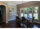 Dining room with large windows, chandelier lighting, and a table with seating for six at 2725 Belmont View Loop, Cary, NC 27519