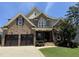Beautiful brick home with a two-car garage, manicured lawn, and mature landscaping at 2725 Belmont View Loop, Cary, NC 27519