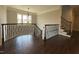 Open foyer with hardwood floors, wrought iron railings, and a staircase leading to the lower level at 2725 Belmont View Loop, Cary, NC 27519