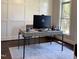 Contemporary office with a modern desk, white walls, and a view of the garden at 2725 Belmont View Loop, Cary, NC 27519