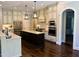 Kitchen featuring granite countertops, a central island, custom cabinets, and stainless appliances at 2725 Belmont View Loop, Cary, NC 27519