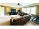 Spacious living room with a large sectional, large windows, and a ceiling fan at 2725 Belmont View Loop, Cary, NC 27519