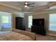 Spacious main bedroom featuring tray ceilings, a ceiling fan and a view to the ensuite bathroom at 2725 Belmont View Loop, Cary, NC 27519