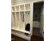 Mudroom with built-in storage cubbies, hooks, and a view into the laundry room at 2725 Belmont View Loop, Cary, NC 27519