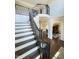Grand staircase with detailed wrought iron banister, hardwood steps, and an open foyer at 2725 Belmont View Loop, Cary, NC 27519