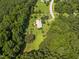 Areal view of a house and wooded acreage with extensive privacy and natural beauty at 3000 Hidden Spring Ln, Oxford, NC 27565