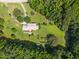 Aerial view of a secluded property featuring a well-maintained house, surrounded by trees at 3000 Hidden Spring Ln, Oxford, NC 27565