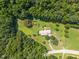 Complete aerial view of the home with the surrounding yard and forest at 3000 Hidden Spring Ln, Oxford, NC 27565