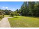 Spacious backyard with healthy green lawn and mature trees providing ample shade at 3000 Hidden Spring Ln, Oxford, NC 27565
