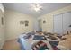 Bright bedroom with a bed featuring a blue patchwork quilt and double door closet at 3000 Hidden Spring Ln, Oxford, NC 27565
