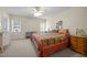 A charming bedroom with a ceiling fan and plenty of natural light from two windows at 3000 Hidden Spring Ln, Oxford, NC 27565