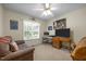 Well-lit bedroom with a comfortable sofa, desk, and a large window offering natural light at 3000 Hidden Spring Ln, Oxford, NC 27565