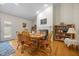 Dining area featuring hardwood floors, a fireplace, and built-in bookshelves for a warm, inviting atmosphere at 3000 Hidden Spring Ln, Oxford, NC 27565