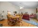 Open-concept dining area leads to the living room and kitchen, with hardwood floors and a ceiling fan at 3000 Hidden Spring Ln, Oxford, NC 27565