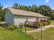 Rear view of home showcasing fenced yard, back deck, and landscaping at 3000 Hidden Spring Ln, Oxford, NC 27565