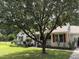 Charming home with red shutters, a cozy front porch, mature trees, and a well-manicured lawn at 3000 Hidden Spring Ln, Oxford, NC 27565