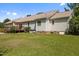 Rear exterior view of house, showing deck, lawn, and air conditioning system at 3000 Hidden Spring Ln, Oxford, NC 27565