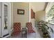 Inviting front porch featuring a cozy seating area and decorative plants at 3000 Hidden Spring Ln, Oxford, NC 27565