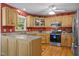 A fully equipped kitchen with modern appliances and wooden cabinets at 3000 Hidden Spring Ln, Oxford, NC 27565