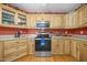 Well-lit kitchen featuring wooden cabinets, stainless steel appliances and orange walls at 3000 Hidden Spring Ln, Oxford, NC 27565