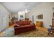 Cozy living room with hardwood floors, vaulted ceilings, and a comfortable, vintage-style red sofa at 3000 Hidden Spring Ln, Oxford, NC 27565