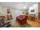 Living room with hardwood floors, fireplace, ceiling fan, and furniture at 3000 Hidden Spring Ln, Oxford, NC 27565