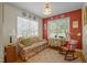 Cozy living room features hardwood floors, many windows for natural light, and colorful walls at 3000 Hidden Spring Ln, Oxford, NC 27565