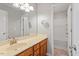 Bright bathroom with a wooden vanity, a mirror, and a shower tub at 3021 Winding Waters Way, Raleigh, NC 27614