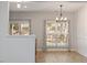 Bright dining area featuring modern light fixture and large windows with patterned curtains at 3021 Winding Waters Way, Raleigh, NC 27614