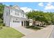 Street view of a two-story townhouse showcasing a landscaped front yard, sidewalk, and attached garage at 3021 Winding Waters Way, Raleigh, NC 27614