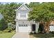 Charming two-story home with a well-manicured lawn, attached garage, and mature landscaping at 3021 Winding Waters Way, Raleigh, NC 27614