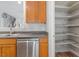 A cozy kitchen includes a stainless steel dishwasher and a well-organized pantry on the side at 3021 Winding Waters Way, Raleigh, NC 27614