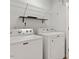 Laundry area with white washer and dryer, wire rack shelving, and white walls at 3021 Winding Waters Way, Raleigh, NC 27614