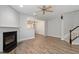 Open-concept living room featuring a fireplace and seamless flow into the adjacent dining area at 3021 Winding Waters Way, Raleigh, NC 27614