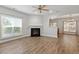 Sun-filled living room featuring new laminate flooring, a cozy fireplace, and neutral paint colors at 3021 Winding Waters Way, Raleigh, NC 27614