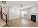 Inviting living room with new laminate floors, gas fireplace, and a staircase with white risers at 3021 Winding Waters Way, Raleigh, NC 27614