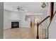 Open-concept living room with modern fireplace, new laminate floors, and views of the dining area at 3021 Winding Waters Way, Raleigh, NC 27614
