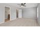 Large bedroom features neutral carpet, a ceiling fan and adjacent bath and closet entrances at 3021 Winding Waters Way, Raleigh, NC 27614