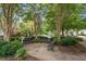 Relax on a park bench in this quiet area with lush trees, green bushes, and winding pathways at 3021 Winding Waters Way, Raleigh, NC 27614