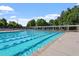 Community pool featuring lap lanes, comfortable seating and a tree lined perimeter at 3021 Winding Waters Way, Raleigh, NC 27614