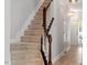 Carpeted staircase with white banisters and dark wood handrail leading to the upper level of the home at 3021 Winding Waters Way, Raleigh, NC 27614