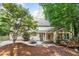 Private backyard featuring a stone patio, perfect for outdoor dining and entertaining, surrounded by mature trees at 3025 Bentwillow Dr, Fuquay Varina, NC 27526