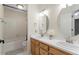 Bright bathroom features dual sinks, wood cabinets, tub and tile flooring at 3025 Bentwillow Dr, Fuquay Varina, NC 27526