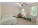Bright bedroom with neutral walls, ceiling fan, and windows providing plenty of natural light at 3025 Bentwillow Dr, Fuquay Varina, NC 27526