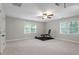 Spacious bonus room featuring windows, carpet flooring and ceiling fan at 3025 Bentwillow Dr, Fuquay Varina, NC 27526