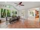 Bright dining area features large windows overlooking lush landscaping and backyard views at 3025 Bentwillow Dr, Fuquay Varina, NC 27526