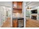 Stylish dry bar offers a wine fridge, granite countertop, and convenient access to the living room at 3025 Bentwillow Dr, Fuquay Varina, NC 27526