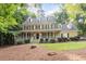 Inviting two-story home with a classic design and a spacious front porch, offering curb appeal and charm at 3025 Bentwillow Dr, Fuquay Varina, NC 27526