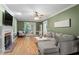 Spacious living room with a fireplace, hardwood floors, and large windows, perfect for relaxing or entertaining at 3025 Bentwillow Dr, Fuquay Varina, NC 27526