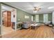 Open-concept living room with hardwood floors, a fireplace, and easy access to the kitchen and outdoor spaces at 3025 Bentwillow Dr, Fuquay Varina, NC 27526
